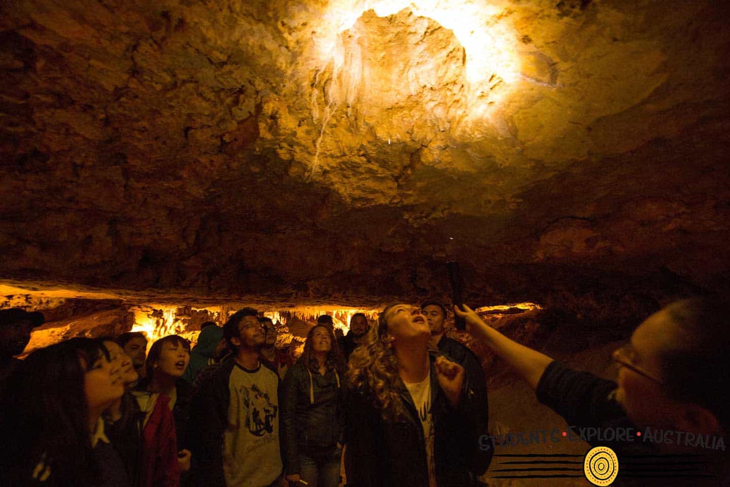 Students learning about a cave ceiling inside a cave
