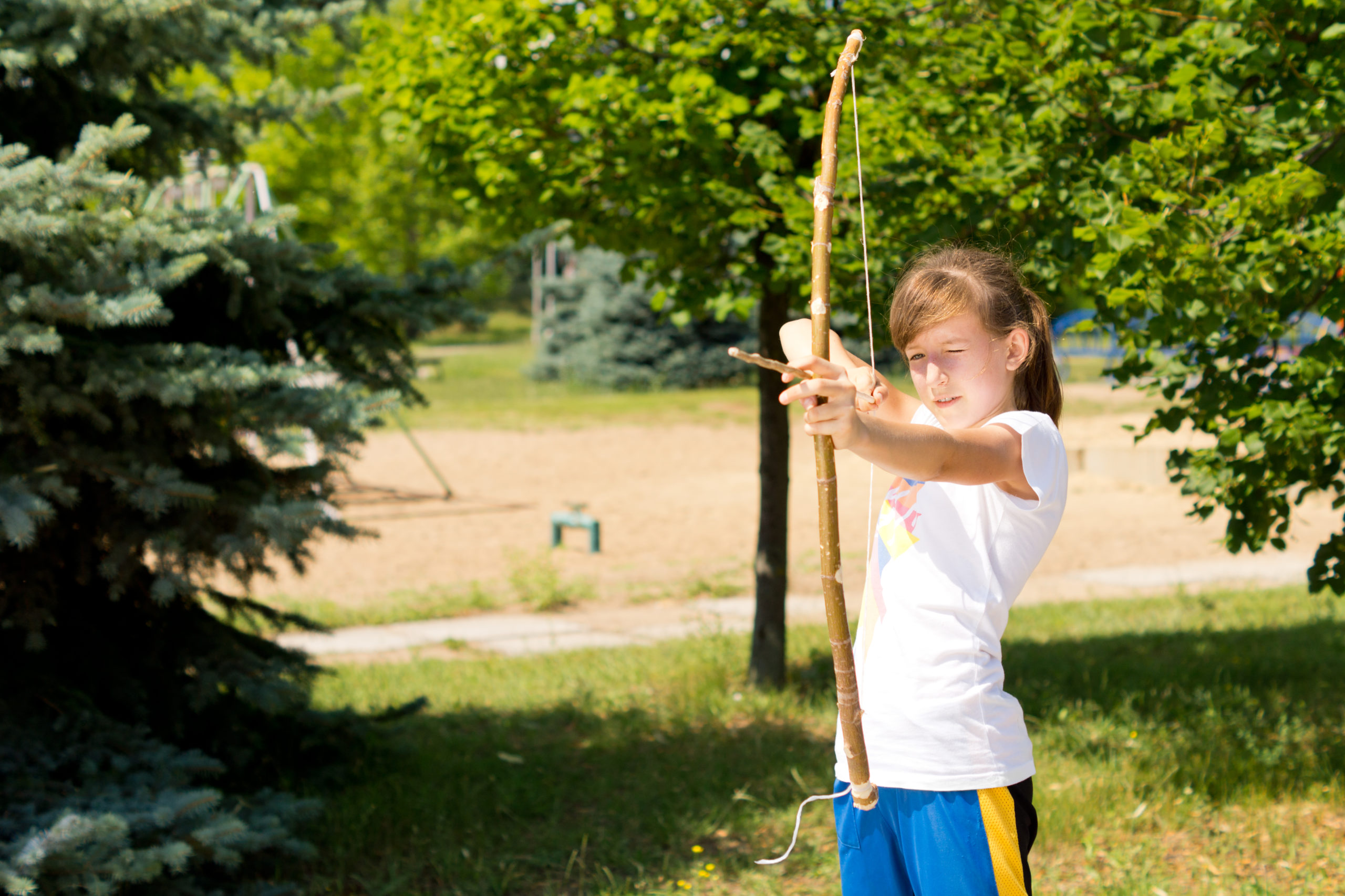 Girl is practicing the sport of archery outdoors