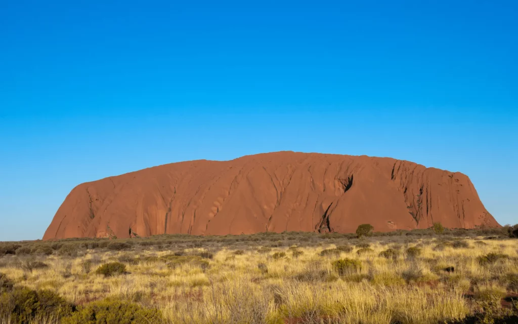 An Image of Uluru or Ayers Rock which is a massive sandstone monolith in the heart of the Northern Territory.