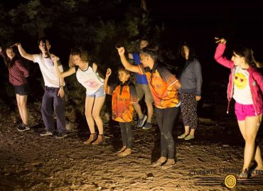Children practicing aboriginal dance at night