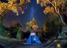 Blue tent under a starry sky